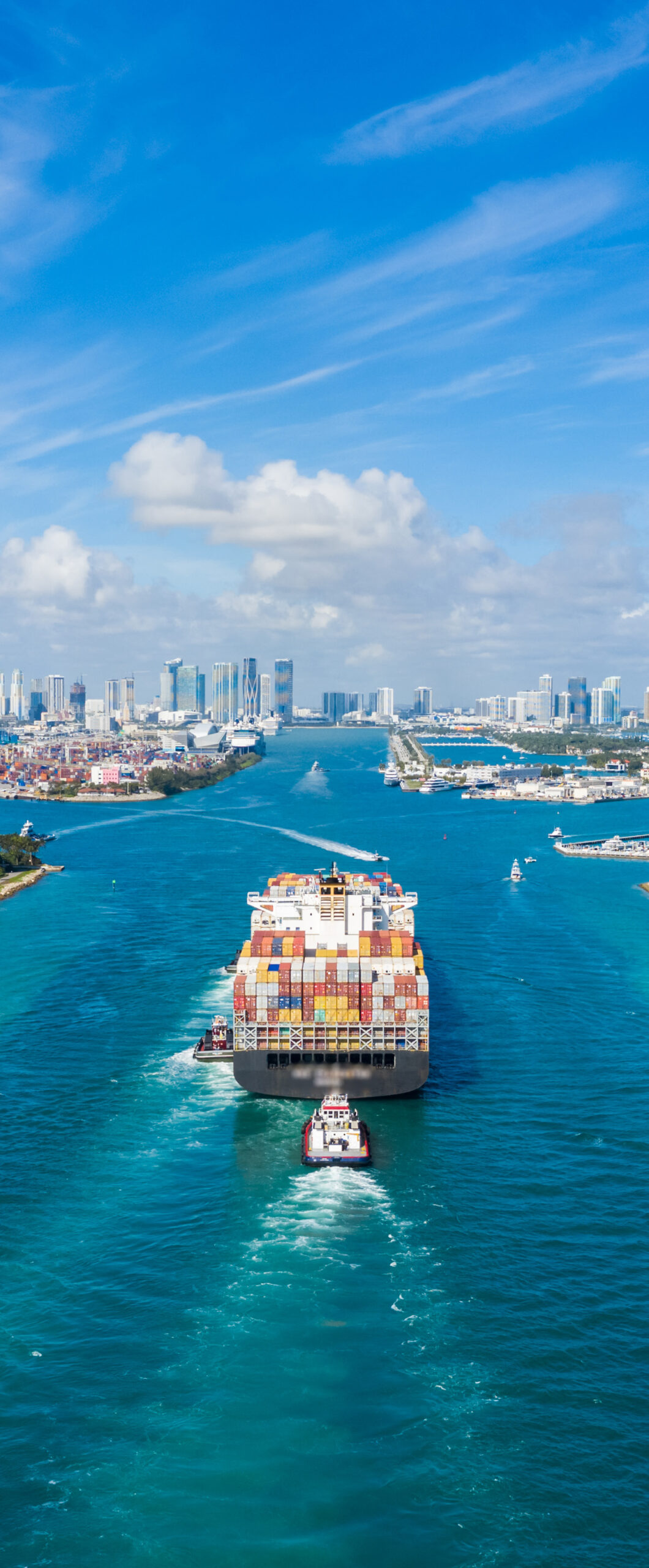 A cargo ship with containers guided by tugboats, symbolizing AI's role in predicting shipping patterns and detecting high-risk anomalies.